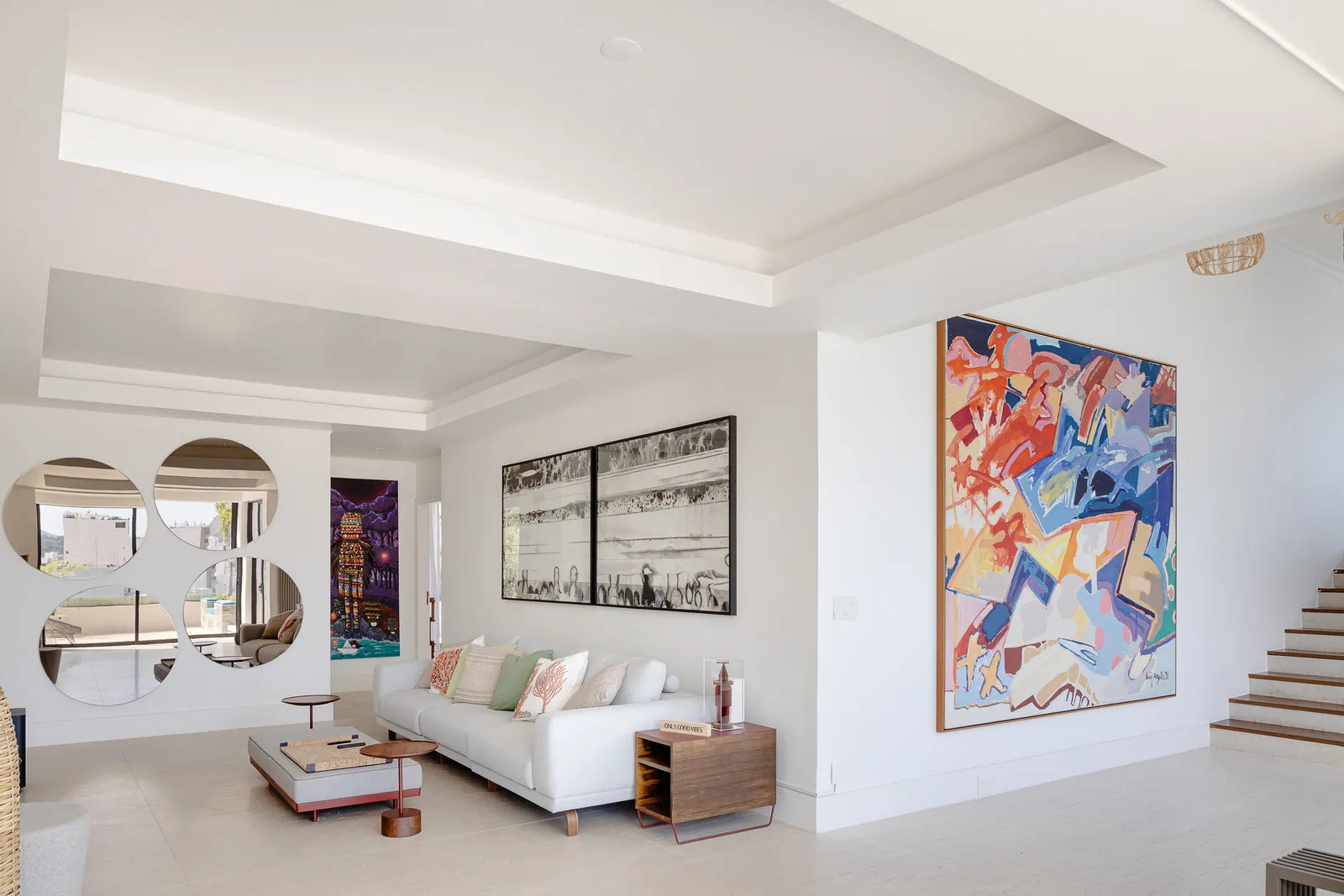 Seating area with television and circular mirror composition