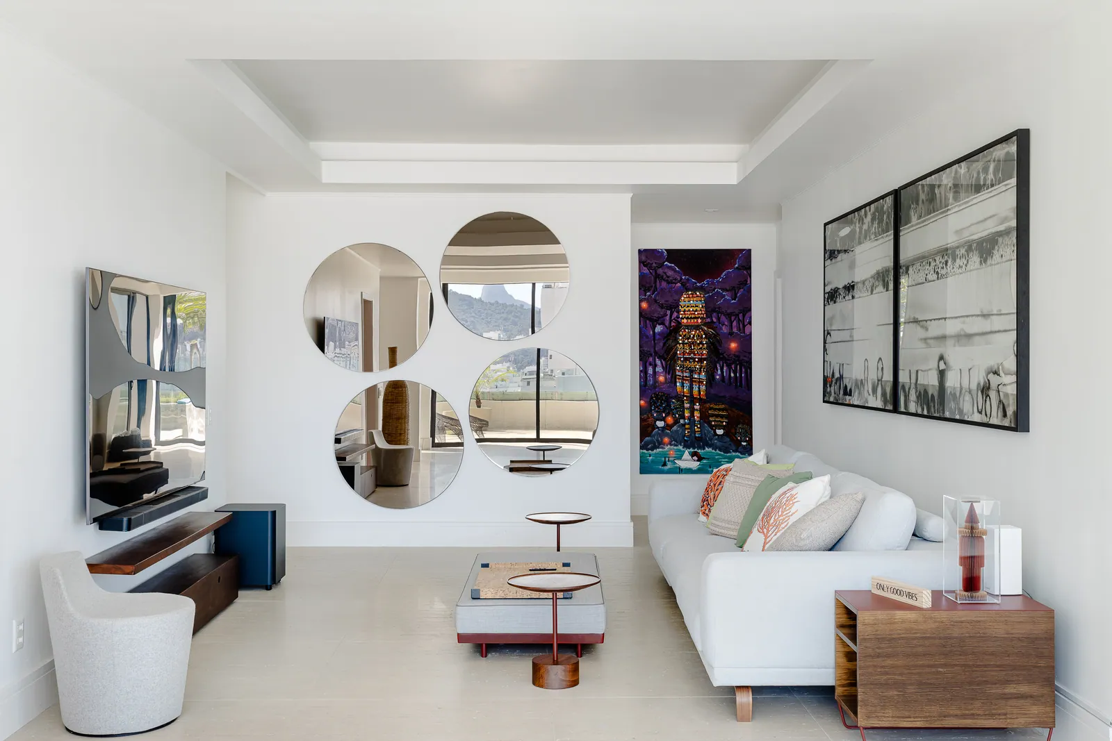Living room with black-and-white photographs, terrace beyond