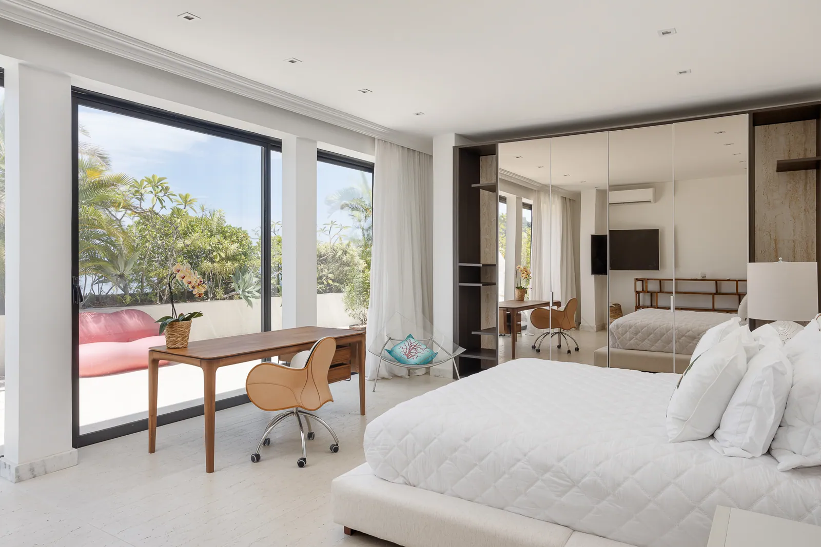 Daybed against the glass, the hills of Rio beyond