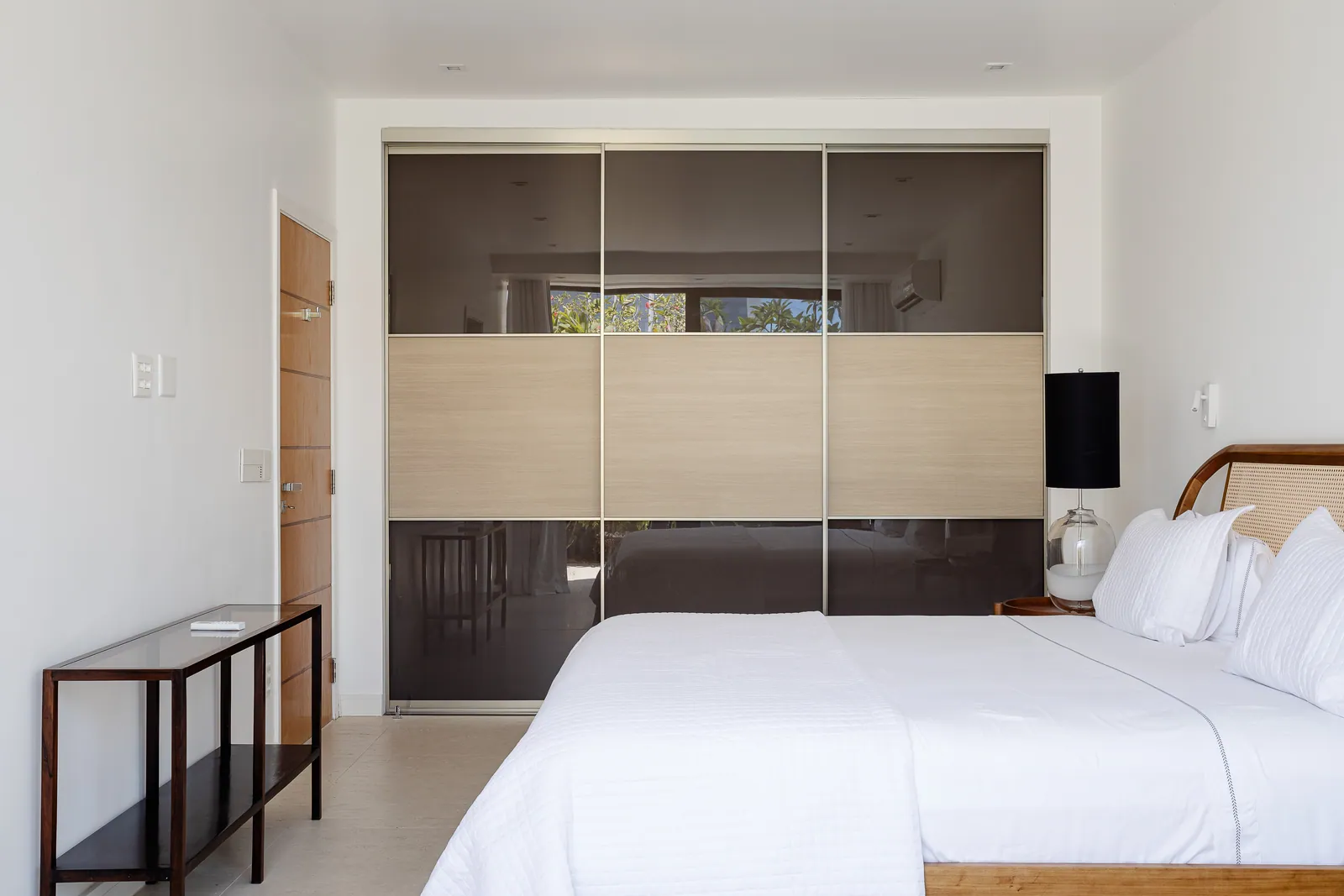 Bedroom with wood headboard and garden outlook