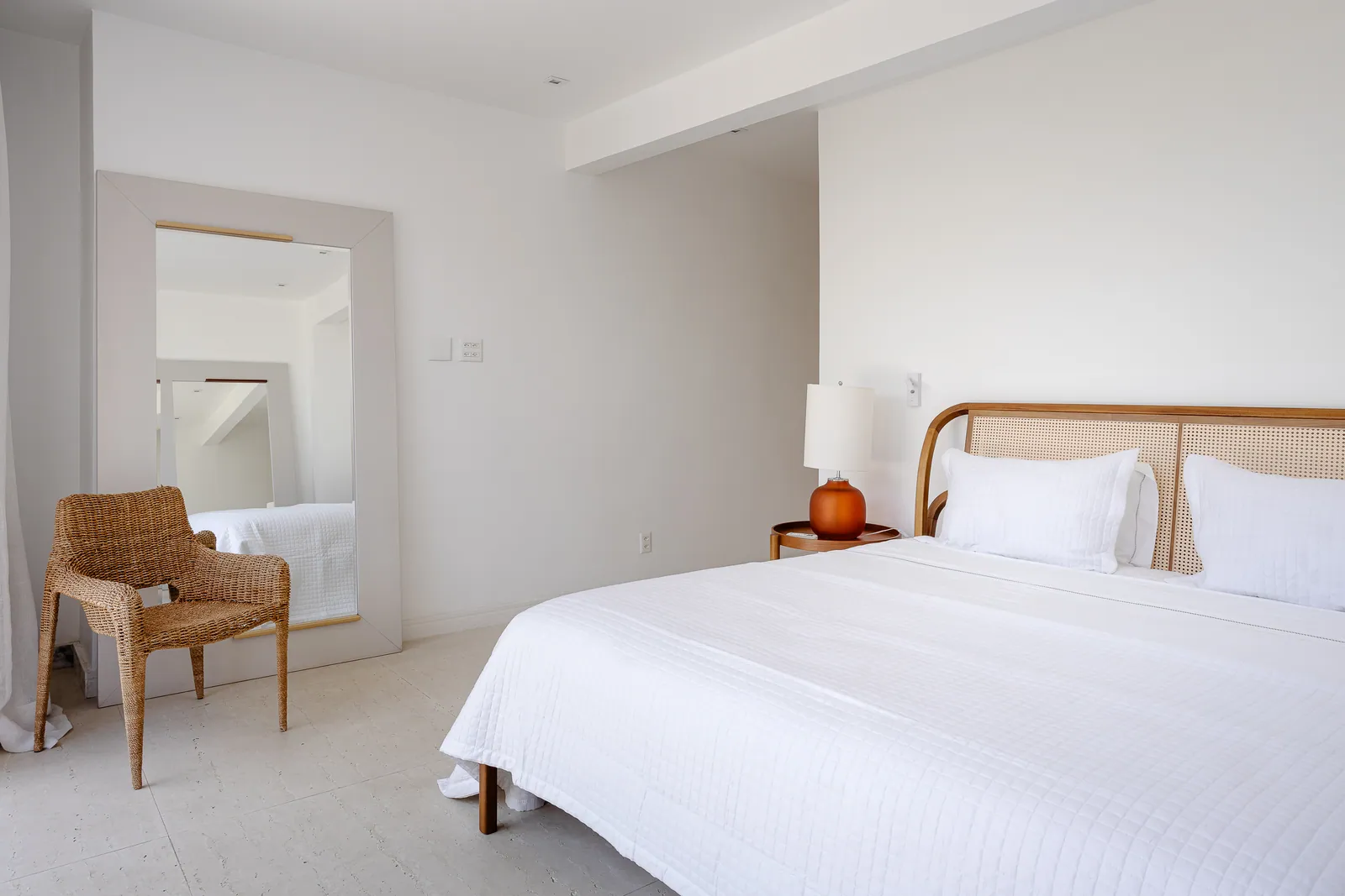 Bedroom with full-height mirror and sheer curtains