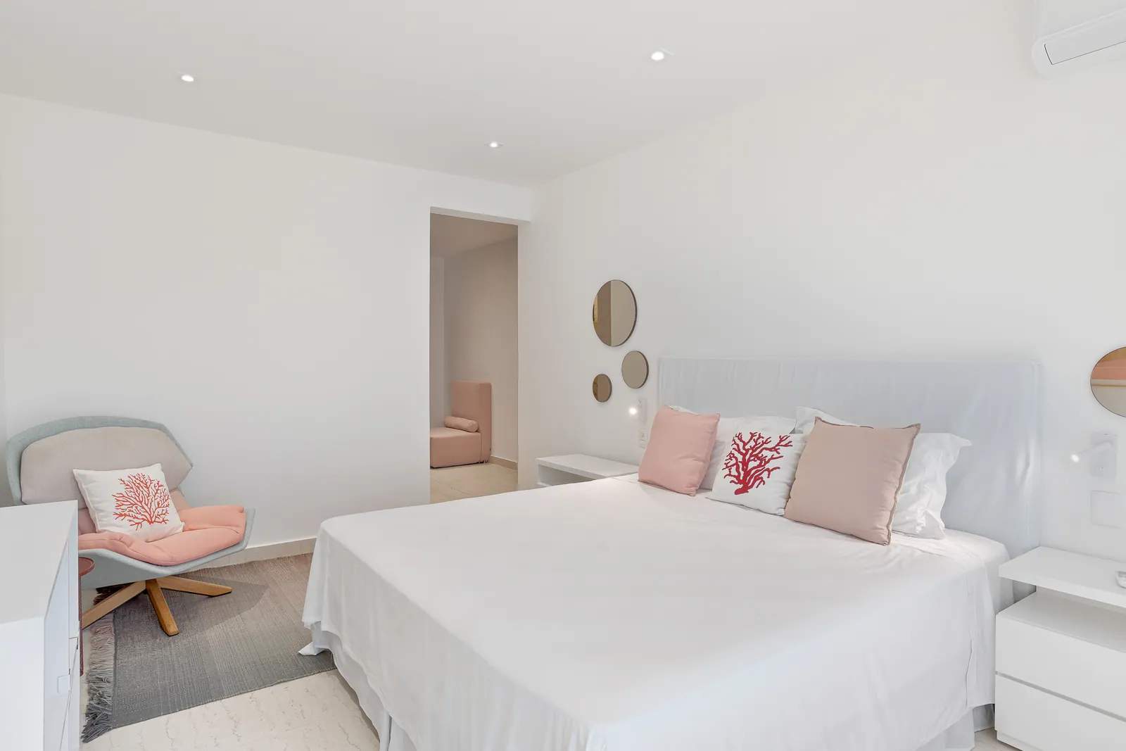 Bedroom with soft pink cushions and window seat