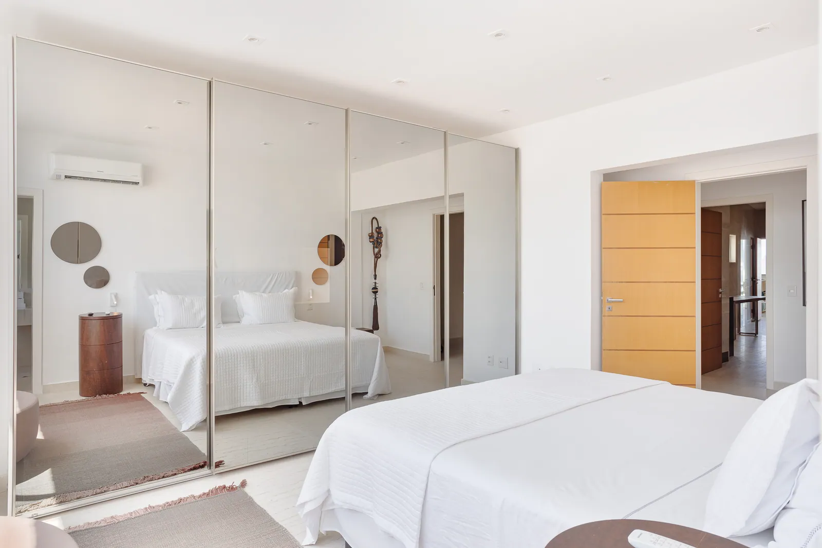 Bedroom with mirrored wall and city view
